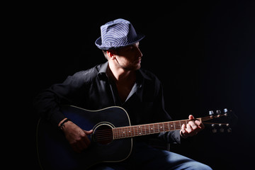 Young musician playing acoustic guitar and singing,