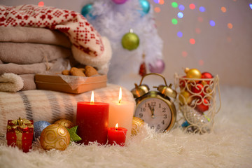Composition with plaids, candles and Christmas decorations,