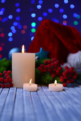Candles and Christmas decoration on bright background