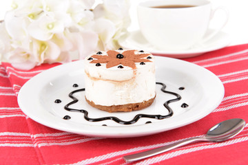 Sweet cake with chocolate on plate on table close-up