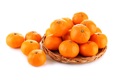 Ripe tangerines on wicker stand isolated on white