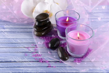 Beautiful colorful candles and  orchid flowers,