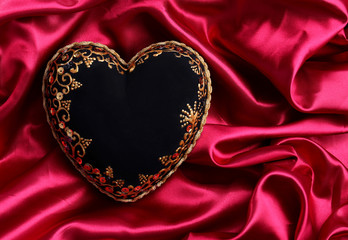 Decorative black heart, on color fabric