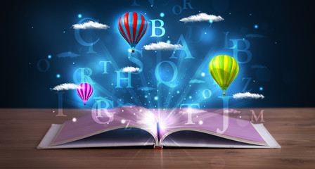 Open book with glowing fantasy abstract clouds and balloons