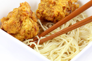 Noodles with snacks in bowl with chopsticks