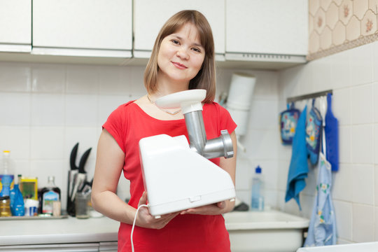 woman with electric mincing machine