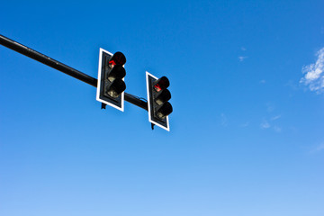 Traffic lights on blue sky background