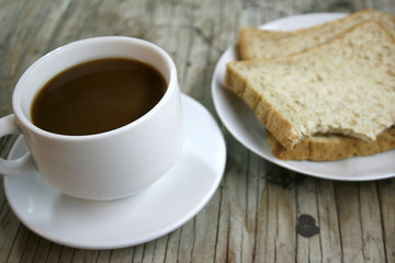 plate with a cup of coffee and bread