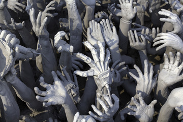 White Statue Hands Reaching Out Of Hell