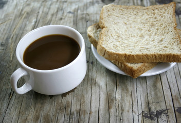 plate with a cup of coffee and bread