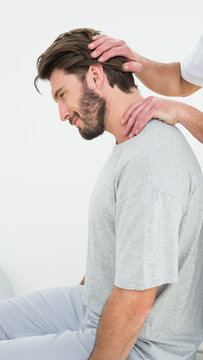 Side view of a man getting the neck adjustment done