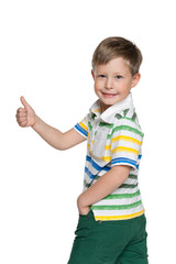 Walking boy holds his thumb up