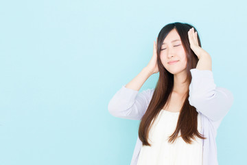 young asian woman thinking on blue background