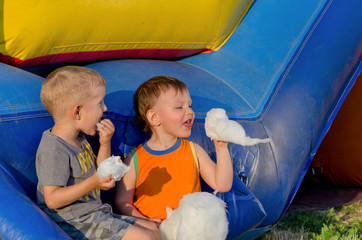 Two young friends eating candy floss