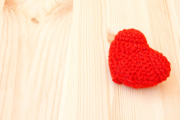 red knitted toy in the shape of heart