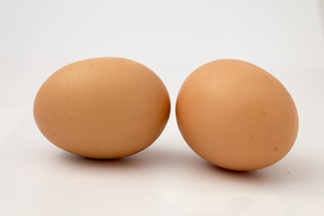 Two chicken eggs on white background