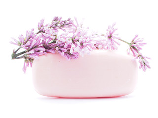 soap and flowers on white background