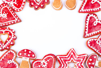 Gingerbread cookies and spices over white background close up