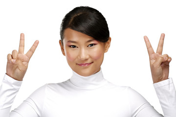 Beautiful happy asian girl showing victory positive sign