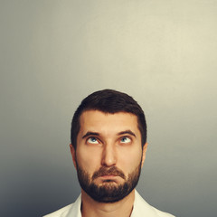 portrait of foolish man over grey