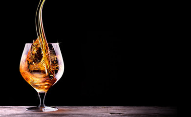 Cognac or brandy on a black