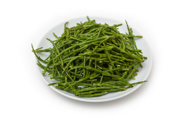 Plate of Samphire isolated on a white studio background.
