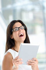 Happy woman holding digital tablet