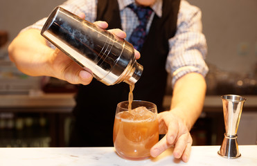 Bartender is making a cocktail