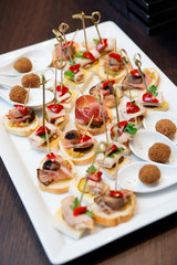 Various snacks in plate on restaurant table