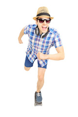 Excited guy with hat and sunglasses skating on a skate board