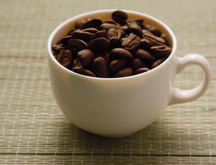 A cup and coffee beans, from above