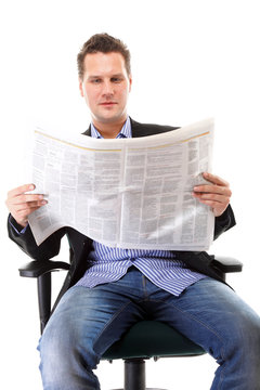 Businessman reading a newspaper isolated