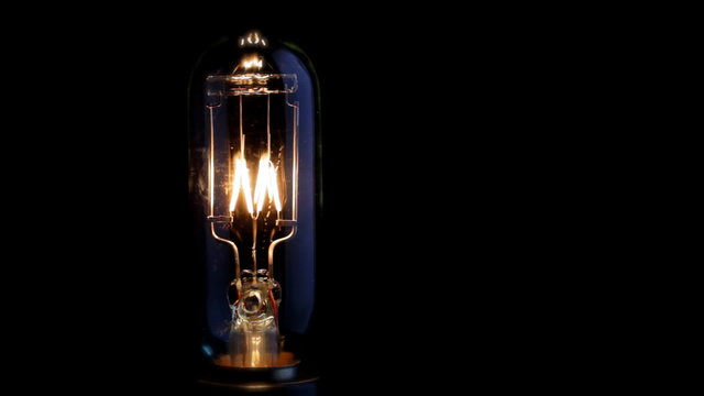 Real light bulb turning on, flickering and turning off