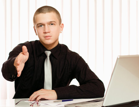 Portrait of a business man giving his hand