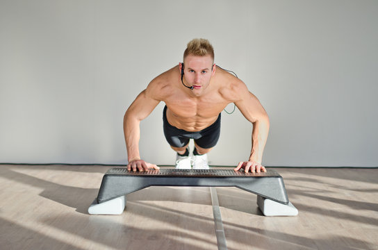 Young Aerobics Male Coach On Step Teaching Class