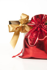 Red bag with gifts and a gold bow