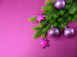 Christmas balls on fir tree, on color background