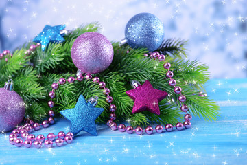 Christmas balls on fir tree, on color background