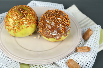 Homemade taffy apples, on napkin, on wooden background