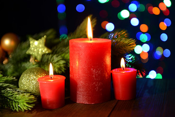 Composition with burning candles, fir tree and Christmas