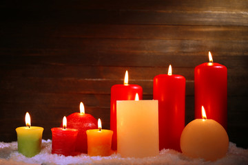 Burning candles on wooden background