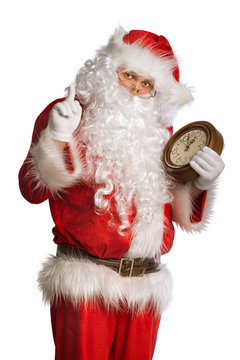 Santa Claus holding a clock showing several  minutes to midnight