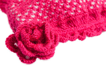 Red-white knitted hat with flowers on a white background