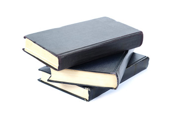 Stack of old books on a white background.