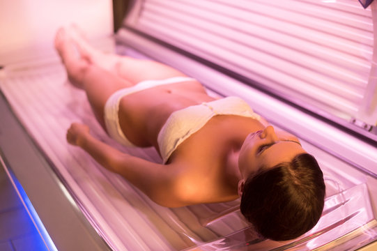 Woman on tanning bed.