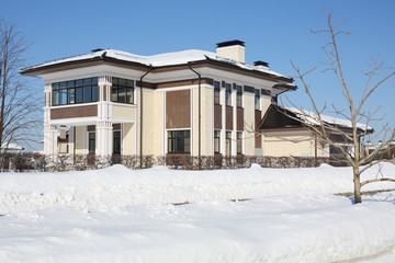 Brown and yellow cottage with garage and loggia at frosty