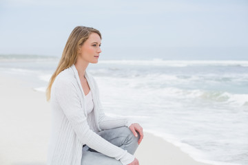 Fototapeta na wymiar Casual young woman relaxing at beach