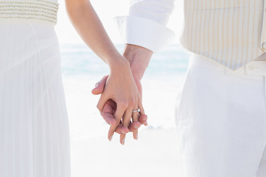 Bride and groom hand in hand