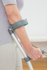 Close-up mid section of a woman with crutches