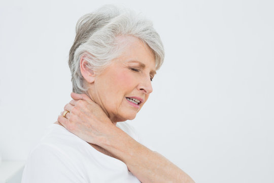 Side View Of A Senior Woman Suffering From Neck Pain